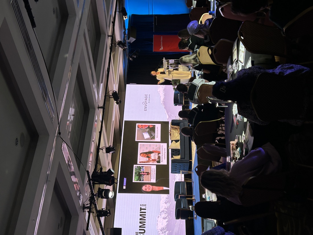 Roi speaking on stage at a business summit